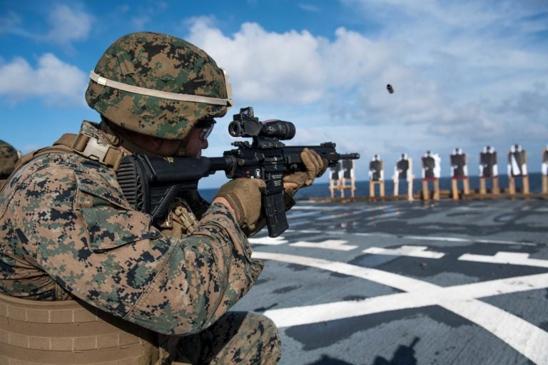 Marine of the 31st Marine Expeditionary Unit, fires an M27