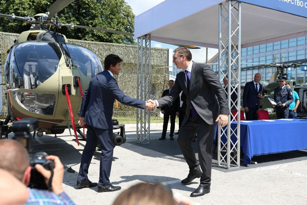 Serbian Minister of Defense Aleksandar Vulin and Airbus Helicopters Germany CEO Wolfgang Schoder shake hands in 2018 (photo courtesy of Airbus Helicopters)