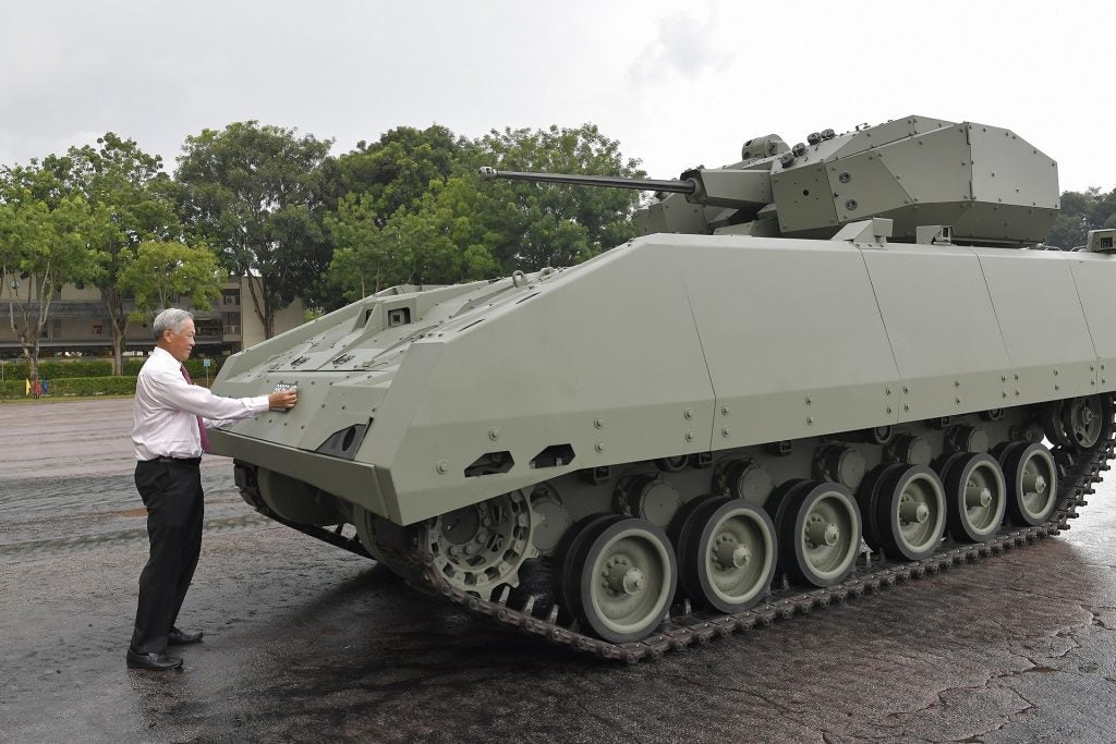 Defense Minister Ng commissions the Hunter Armored Fighting Vehicle by affixing the licence plate on the platform (courtesy Singapore Ministry of Defense)