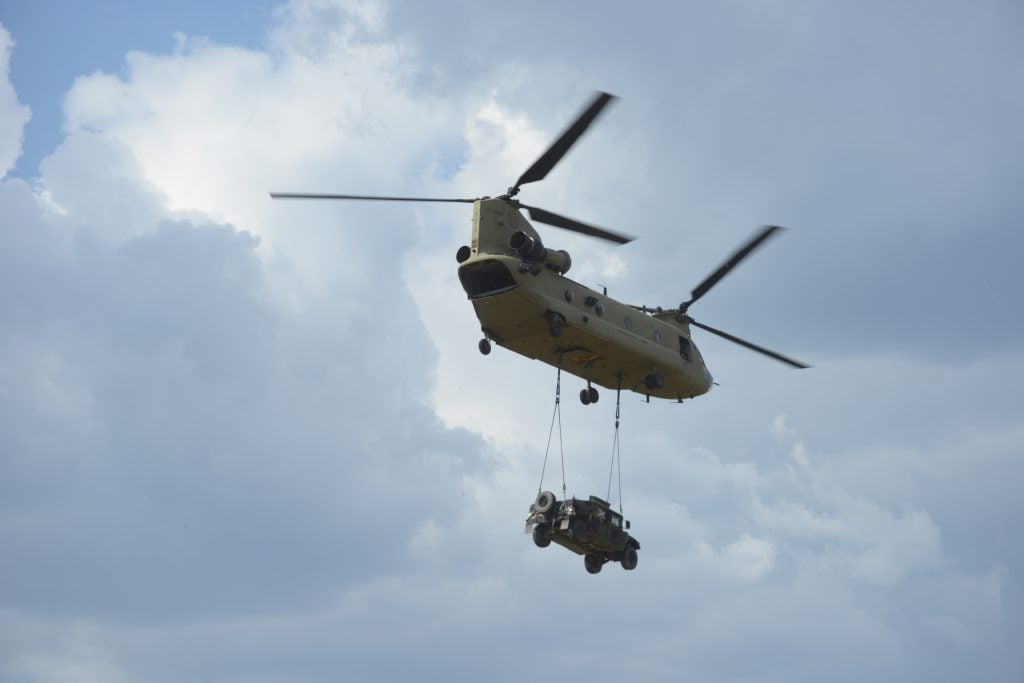 A U.S. CH-47F Chinook Helicopter assigned to Bravo Company, 1st Battalion, 214th Aviation Regiment, 12th Combat Aviation Brigade conducts sling load procedures at the 7th Army Training Command's Grafenwoehr Training Area, Germany, July 26, 2018. (U.S. Army photo by Christoph Koppers)