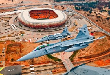 A 2-ship formation of SAAF Gripens over the First National Bank Stadium in Johannesburg, South Africa. (Frans Dely/Saab AB)