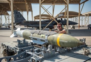 Staff Sgt. Joshua Samuelson, 380th Expeditionary Aircraft Maintenance Squadron F-15E Strike Eagle weapons load crew member, guides a lift driver lowers a GBU-54 onto a trailer September 2019, at Al Dhafra Air Base, United Arab Emirates. The F-15E is a dual-role fighter designed to perform air-to-air and air-to-ground missions with a wide array of munitions at their disposal. (U.S. Air Force photo by Staff Sgt. Chris Thornbury)