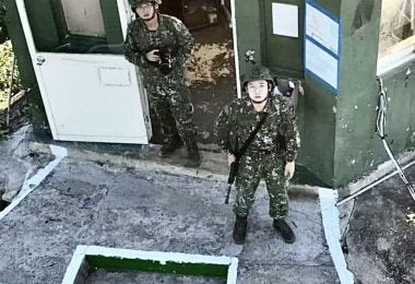 Two Taiwanese Soldiers look up at the offending drone