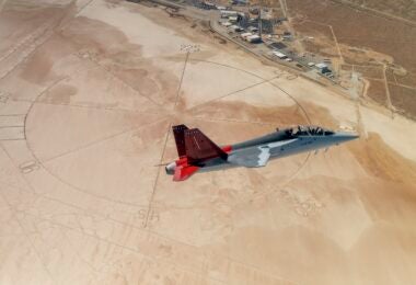 The first T-7A Red Hawk, piloted by USAF test pilot Maj. Jonathan “Gremlin” Aronoff and Boeing test pilot Steve “Bull” Schmidt, soars over Edwards Air Force Base, California, Nov. 8, prior to arrival. The T-7A will replace the 1960s-era T-38 aircraft by providing advanced pilot training capabilities for aviators learning to fly both tactical and bomber aircraft. (Air Force photo by Bryce Bennett)