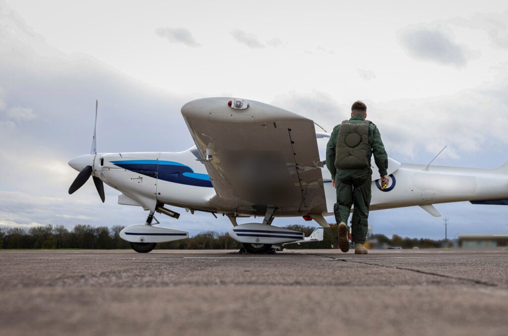 A Ukrainian combat air pilot approaches a Royal Air Force Grob Tutor aircraft (UK Ministry of Defence)