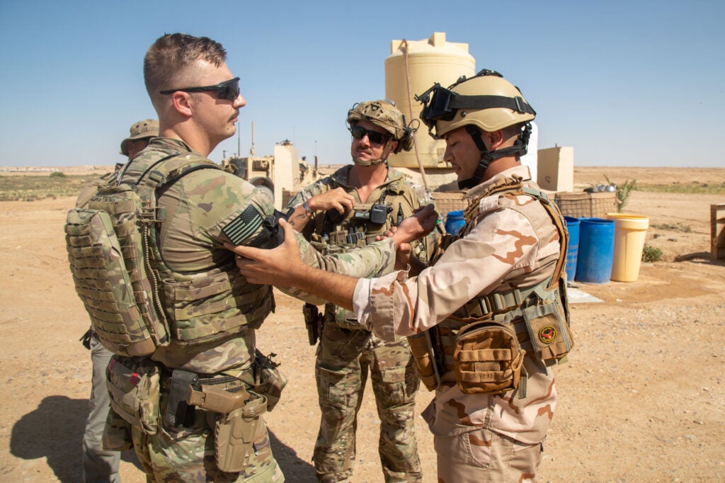 U.S. Army Staff Sgt. Timmy Fair and Spc. Patrick Bergen, assigned to 37th Infantry Brigade Combat Team, 125th Infantry Regiment, 1st Battalion, Combined Joint Task Force – Operation Inherent Resolve, teaches an Iraqi Army soldier how to apply a tourniquet at Al Asad Air Base, Iraq, June 19, 2023. Members of the Coalition maintain readiness to better advise, assist and enable partner forces in the ongoing effort to defeat ISIS. (U.S. Army photo by Spc. Timothy VanDusen)