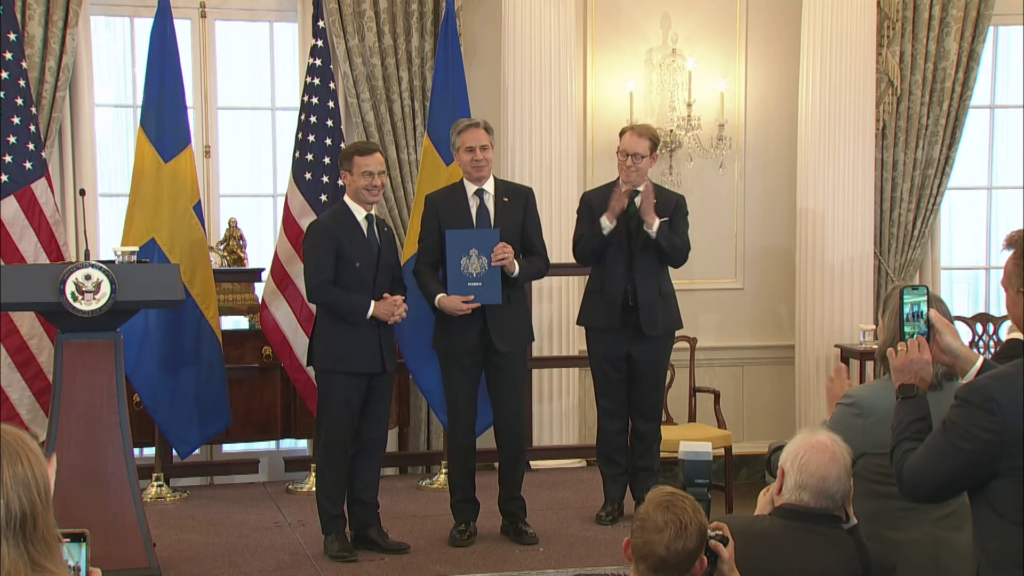 US Secretary of State Antony Blinken holds Sweden's NATO instrument of accession after it was handed over by Swedish Prime Minister Ulf Kristersson (State Department)