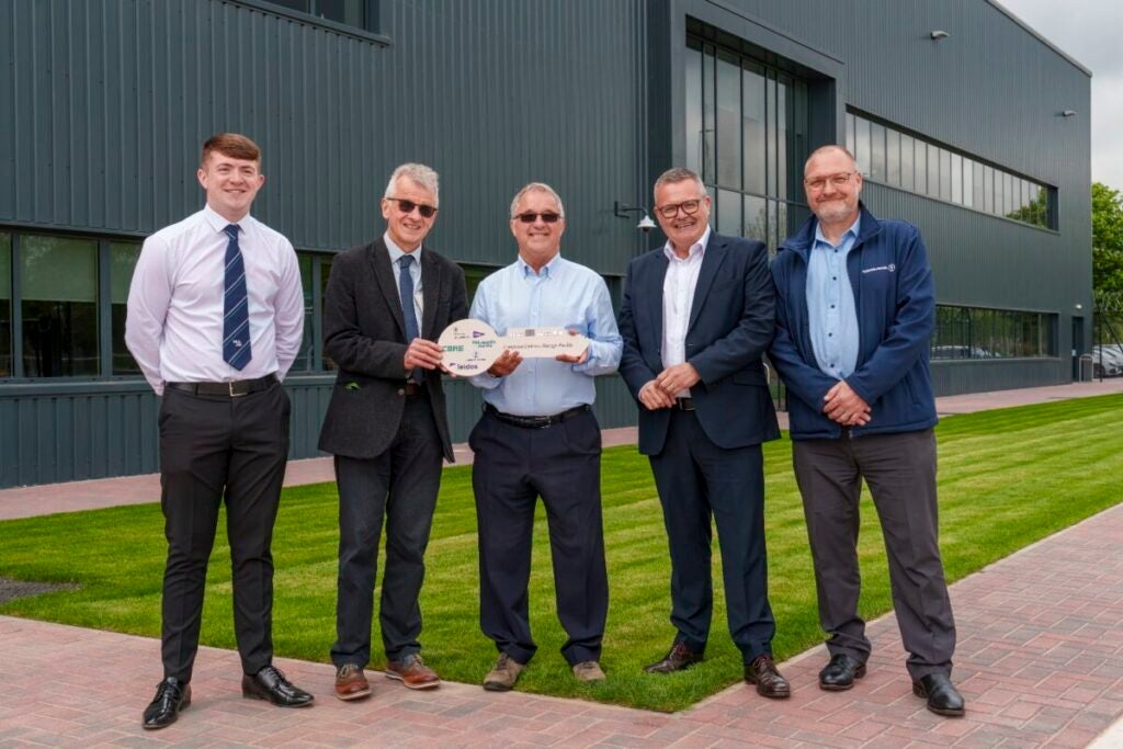 Pictured L-R in front of the new site: Aiden Ewing, Trainee Site Manager at McLaughlin & Harvey; Les Millar, Project Director at DE&S; Andy Morris, Assistant Head Commissioning and Management Organisation at DE&S; Ross Bannerman, Chief Operations Officer at Team Leidos and Brian Franklin, Director of Operations at Kuehne & Nagel (Defence Equipment & Support)