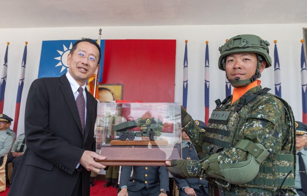 Taiwanese defense minister Wellington Koo is presented with a scale model of a M142 HIMARS launcher at the commissioning ceremony of the Taiwanese Army's first HIMARS unit (Military News Agency)